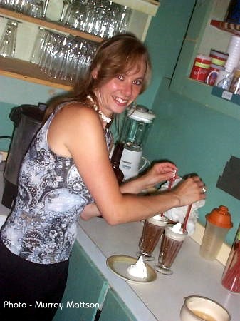 Kim making special coffees - extra cream for Myrna